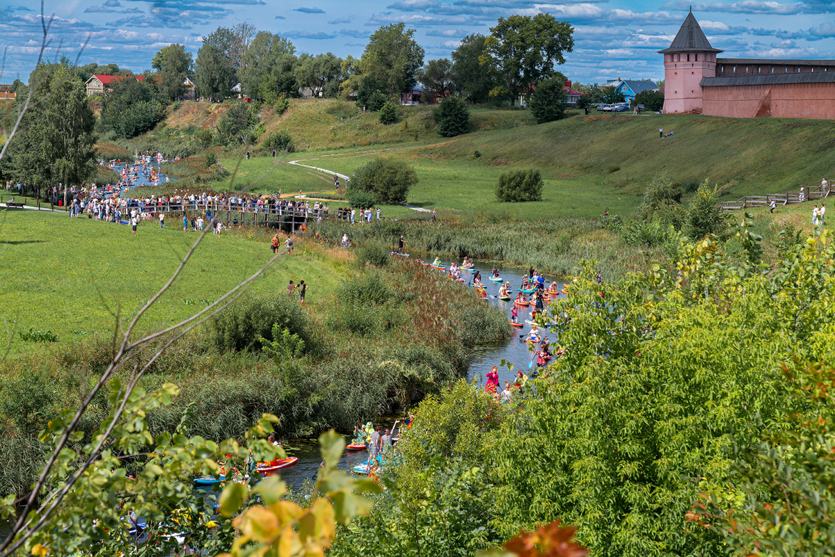Sup-карнавал в Суздале точно войдет в топ ярких ивентов уходящего лета. Костюмированный фестиваль собрал более тысячи участников из разных регионов страны, которые примерили самые неожиданные образы. В минувшие выходные по Каменке бок о бок проплыли дед Мазай, Бэтмен, Марио. Кто еще вышел на воду, читайте в материале «Ключ-Медиа».